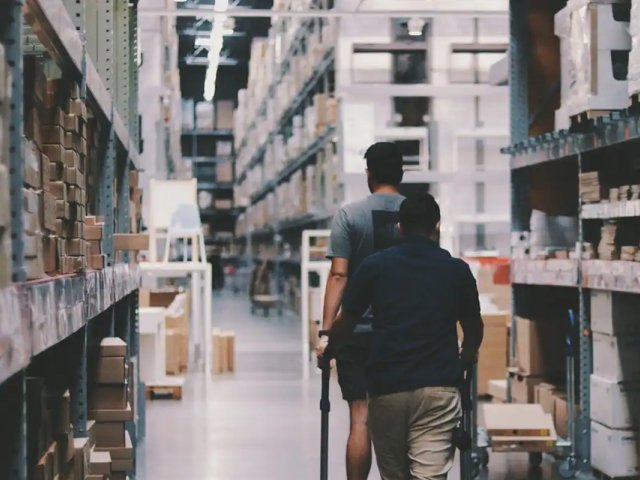two-people-walking-through-a-warehouse - moter two-people-walking-through-a-warehouse - moter
